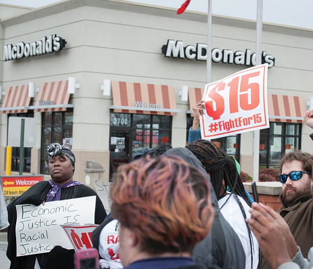 On Monday, protests were held across the nation marking the anniversary of the Memphis strike and calling for higher wages for workers. Bernadette Brown, left, holds a sign outside a Richmond fast food restaurant, while Daniel Henegar, right, and others show their support. The protests were organized by Fight for $15 and the New Poor People’s Campaign, which is led by the Rev. William J. Barber II of North Carolina.