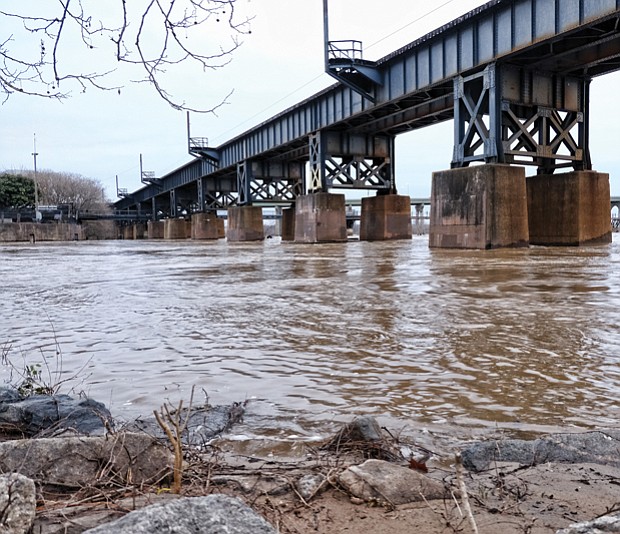 A swollen James River flows by the railroad bridge near Brown’s Island. Fueled by recent heavy rains upstream, the river rose above flood stage running through Richmond. Data show the river crested at 15.4 feet Monday at the Westham gauge, or about 3 feet above flood stage. A kayaker who got stuck Monday in the rapids nearly drowned before he was rescued by city emergency personnel. On Tuesday, when this photo was taken, the river was still running above 11 feet at the City Locks near Shockoe Bottom, also 3 feet above flood stage. The river fell below flood stage Wednesday. The U.S. Weather Service and the U.S. Geological Survey are forecasting that the river will drop to a less treacherous 7 feet by Friday.   