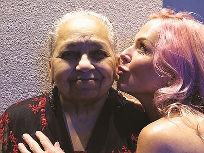 Longtime Portland civil rights leader Kathleen Saadat (left) gets some love from Portland singer Storm Large and the band Pink Martini. 