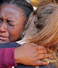 Marla Eveillard, 14, weeps as she hugs friends before the start of a vigil at Parkland Baptist Church in Florida on Feb. 15, the day after the Douglas High School massacre in which 17 people were killed and many others were wounded.