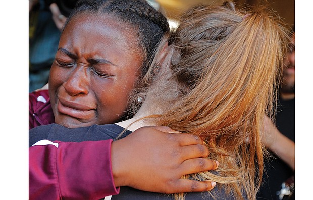 Marla Eveillard, 14, weeps as she hugs friends before the start of a vigil at Parkland Baptist Church in Florida on Feb. 15, the day after the Douglas High School massacre in which 17 people were killed and many others were wounded.