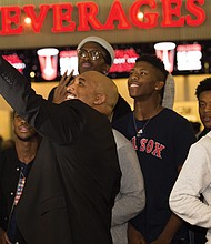 Richmond City Councilman Michael J. Jones takes a selfie with students who accepted his challenge to perform a kind act for others and then received free tickets to last Thursday’s premiere of “Black Panther” at Bow Tie Movieland in Richmond.