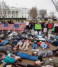 Student demonstrators stage a lie-in Monday outside the White House in Washington seeking tougher gun control laws. 