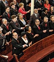 Left, the family of Dr. Wyatt Tee Walker and others attending last Saturday’s memorial service for the late civil rights icon join hands to sing “We Shall Overcome.” Dr. Walker’s wife of 67 years, Theresa Ann Walker, second from left in front pew, was his college sweetheart.