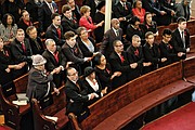 Left, the family of Dr. Wyatt Tee Walker and others attending last Saturday’s memorial service for the late civil rights icon join hands to sing “We Shall Overcome.” Dr. Walker’s wife of 67 years, Theresa Ann Walker, second from left in front pew, was his college sweetheart.