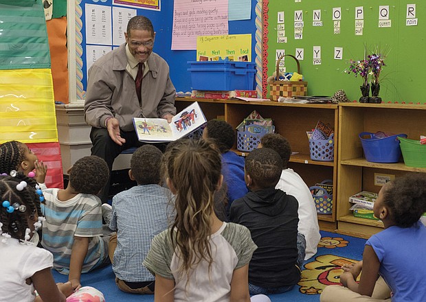 The joy of reading // Theodore Mosley reads to first-graders at Bellevue Elementary in Church Hill last Friday. Mr. Mosley was part of the 100 Men Read project of Mt. Gilead Full Gospel International Ministries. Sheriff Irving was taking part in the annual Read Across America effort to read to children in schools and day care centers. The National Education Association sponsors the effort to promote reading and honor the late noted children’s author Dr. Seuss. Additional volunteers will read to children in Richmond Public Schools and other area schools and programs on Friday, March 2, the birthday of Dr. Seuss, the pen name of Theodor S. Geisel.   