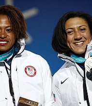 Lauren Gibbs, left, and Elena Meyers Taylor show off their silver medals won in the two-woman bobsled competition Feb. 22 as they stand for the medals ceremony at the Winter Olympics in Pyeongchang, South Korea.