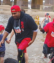 Cityscape // Mal Nanayakkara, left, and James Sinnie wade in the James River during the event sponsored by Keep Virginia Beautiful to raise money for its programs to beautify Richmond and the state, reduce littering and increase recycling. The wintry dip capped a program that also involved volunteers picking up trash along the riverbank and participating in a 5K Walk-Run. 
