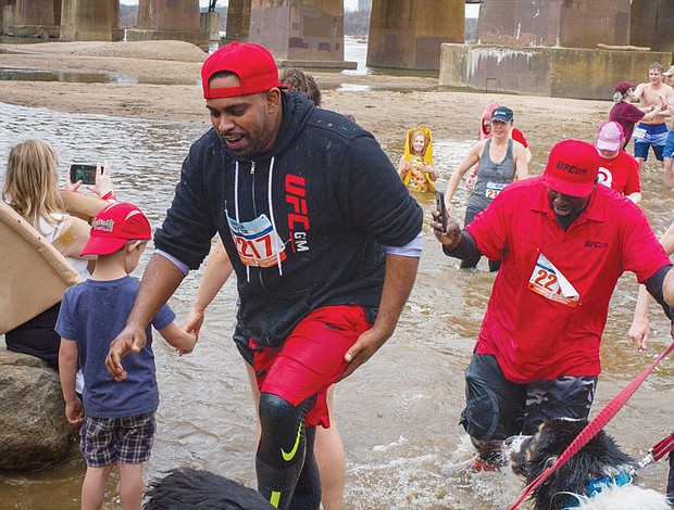 Cityscape // Mal Nanayakkara, left, and James Sinnie wade in the James River during the event sponsored by Keep Virginia Beautiful to raise money for its programs to beautify Richmond and the state, reduce littering and increase recycling. The wintry dip capped a program that also involved volunteers picking up trash along the riverbank and participating in a 5K Walk-Run. 
