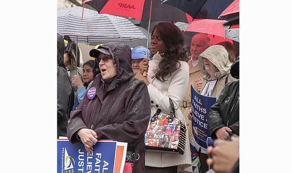 Under the shadow of the Bell Tower on Capitol Square, hundreds of people from across Virginia rallied on a rainy ...