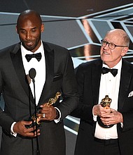 Retired NBA star Kobe Bryant, left, and Disney animator Glen Keane accept Oscars for best animated short for “Dear Basketball” at Sunday’s awards show. Social media blew up, citing an irony in Mr. Bryant’s winning an award in the #MeToo era calling out sexual harassment in light of the 2003 accusation that he sexually assaulted a Colorado hotel employee. The criminal case was dropped and the civil suit against him was settled out of court.