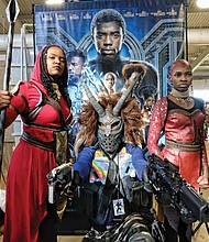 ‘Black Panther’ flair // This trio appears to be straight out of the film “Black Panther” as they take part in VA Comicon last Saturday at the Old Dominion Building at Richmond Raceway. Frank Lester, center, is outfitted as the movie’s super villain Erik Killmonger. Mia Jones, left, and 12-year-old Cameron Hilliard are dressed as Wakanda warriors, also known as Dora Milaje, the team of female special forces protecting the film’s fictional African nation of Wakanda. VA Comicon, where comic books and toys take center stage, was filled with participants who dressed as popular characters. 

