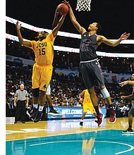 Virginia Union University center Andre Walker, right, goes up to grab the ball from Johnson C. Smith University’s Michael Bowman during Saturday’s CIAA Tournament final at the Spectrum Center in Charlotte, N.C.