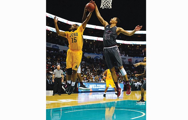 Virginia Union University center Andre Walker, right, goes up to grab the ball from Johnson C. Smith University’s Michael Bowman during Saturday’s CIAA Tournament final at the Spectrum Center in Charlotte, N.C.