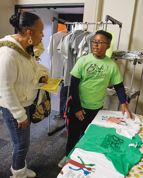 Young entrepreneur //
Move over Jeff Bezos and Elon Musk. The young entrepreneurs, like Brandon Walker of Brandon’s Creative Clothing, are around. Brandon was among a select group of entrepreneurs ages 6 to 17 participating in last Saturday’s inaugural Richmond Children’s Business Fair at the Science Museum of Virginia. The event, sponsored by Acton Academy and Acton School of Business, helped youngsters develop a product or service, create a brand, build a marketing strategy and then open for customers at a one-day marketplace. Above, Brandon talks about his creations with potential customer Verona Williams.