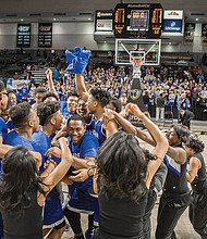 The celebration begins as the John Marshall Justices take the state title last Friday. A perennial powerhouse in the 3A Division, the team finished the season 22-6 after dispatching Western Albemarle High School in the final. 