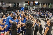 The celebration begins as the John Marshall Justices take the state title last Friday. A perennial powerhouse in the 3A Division, the team finished the season 22-6 after dispatching Western Albemarle High School in the final. 
