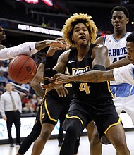 Virginia Commonwealth University forward Justin Tillman loses the ball in a squeeze by University of Rhode Island players during the Atlantic 10 Conference Tournament. Rhode Island defeated the Rams 76-67.