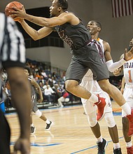 Virginia Union University senior Todd Hughes goes up for a shot against Virginia State University’s defense during the NCAA opener at the VSU Multi-Purpose Center in Ettrick.