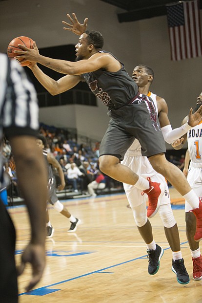 Virginia Union University senior Todd Hughes goes up for a shot against Virginia State University’s defense during the NCAA opener at the VSU Multi-Purpose Center in Ettrick.