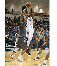 Virginia State University senior Richard Granberry goes up for a shot, helping the Trojans to their 81-76 victory over Virginia Union University last Saturday in the NCAA regionals in Ettrick. VSU would go on to lose to Shippensburg University in Sunday’s semifinal game.