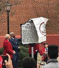 Courtesy of Congressman A. Donald McEachin’s office
Honoring a hometown hero
State, local and federal officials and community members gather for Saturday’s unveiling of a state historic marker honoring the late Lt. Col. Howard L. Baugh, a Petersburg native who was a pilot with the famed Tuskegee Airmen. Lt. Col. Baugh graduated from Virginia State University before entering the Alabama training program. During World War II, he was deployed to Sicily with the 99th Fighter Squadron and flew 135 combat missions. He was awarded a Distinguished Flying Cross, the Air Medal with 3 Oak Leaf Clusters and the French Legion of Honor. President George W. Bush and Congress also awarded Lt. Col. Baugh and the other Tuskegee Airmen with the Congressional Gold Medal in March 2007. Lt. Col. Baugh died in 2008. Unveiling the marker, located at the corner of Sycamore and Old streets in Petersburg, are, from left, Lt. Col. Baugh’s son, Howard L. Baugh Jr., 4th District Congressman A. Donald McEachin, Porcher L. Taylor and other members of the Howard Baugh Chapter of the Tuskegee Airmen Inc. Lt. Col. Baugh’s two other sons, Richard A. Baugh and David P. Baugh, also participated in the event.