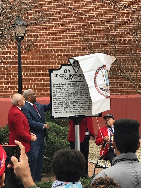 Courtesy of Congressman A. Donald McEachin’s office
Honoring a hometown hero
State, local and federal officials and community members gather for Saturday’s unveiling of a state historic marker honoring the late Lt. Col. Howard L. Baugh, a Petersburg native who was a pilot with the famed Tuskegee Airmen. Lt. Col. Baugh graduated from Virginia State University before entering the Alabama training program. During World War II, he was deployed to Sicily with the 99th Fighter Squadron and flew 135 combat missions. He was awarded a Distinguished Flying Cross, the Air Medal with 3 Oak Leaf Clusters and the French Legion of Honor. President George W. Bush and Congress also awarded Lt. Col. Baugh and the other Tuskegee Airmen with the Congressional Gold Medal in March 2007. Lt. Col. Baugh died in 2008. Unveiling the marker, located at the corner of Sycamore and Old streets in Petersburg, are, from left, Lt. Col. Baugh’s son, Howard L. Baugh Jr., 4th District Congressman A. Donald McEachin, Porcher L. Taylor and other members of the Howard Baugh Chapter of the Tuskegee Airmen Inc. Lt. Col. Baugh’s two other sons, Richard A. Baugh and David P. Baugh, also participated in the event.