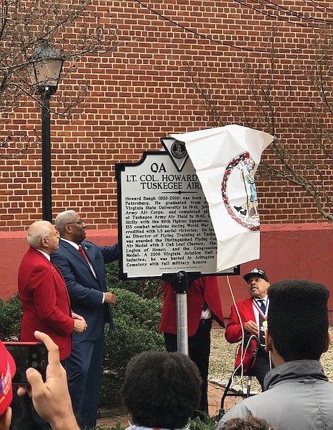 Courtesy of Congressman A. Donald McEachin’s office
Honoring a hometown hero
State, local and federal officials and community members gather for Saturday’s unveiling of a state historic marker honoring the late Lt. Col. Howard L. Baugh, a Petersburg native who was a pilot with the famed Tuskegee Airmen. Lt. Col. Baugh graduated from Virginia State University before entering the Alabama training program. During World War II, he was deployed to Sicily with the 99th Fighter Squadron and flew 135 combat missions. He was awarded a Distinguished Flying Cross, the Air Medal with 3 Oak Leaf Clusters and the French Legion of Honor. President George W. Bush and Congress also awarded Lt. Col. Baugh and the other Tuskegee Airmen with the Congressional Gold Medal in March 2007. Lt. Col. Baugh died in 2008. Unveiling the marker, located at the corner of Sycamore and Old streets in Petersburg, are, from left, Lt. Col. Baugh’s son, Howard L. Baugh Jr., 4th District Congressman A. Donald McEachin, Porcher L. Taylor and other members of the Howard Baugh Chapter of the Tuskegee Airmen Inc. Lt. Col. Baugh’s two other sons, Richard A. Baugh and David P. Baugh, also participated in the event.