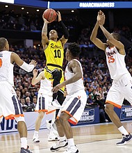 Jairus Lyles of the University of Maryland-Baltimore County goes up for a shot against the University of Virginia Cavaliers during the second half of the upset game last Friday during the NCAA Tournament’s first round in Charlotte, N.C.