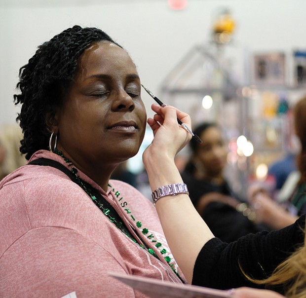 Women’s day // Rochelle Bland gets her makeup done by Elmaze of MAC Cosmetics during the Southern Women’s Show on Saturday at the Richmond Raceway Complex. 
