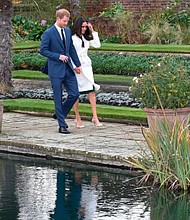 Prince Harry and Meghan//EDDIE MULHOLLAND/AFP/Getty Images