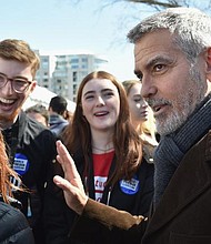 George Clooney marched alongside the demonstrators calling for stricter gun control. 