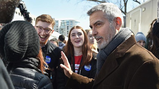 George Clooney marched alongside the demonstrators calling for stricter gun control. 