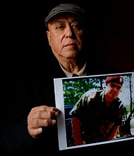 Miguel Perez holds a photo of his son, Miguel Perez Jr., on April 4, 2017 in Chicago.