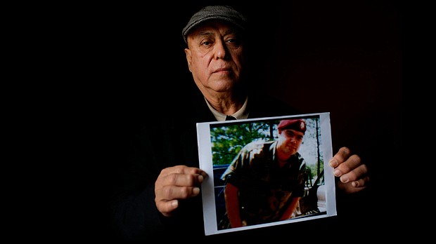 Miguel Perez holds a photo of his son, Miguel Perez Jr., on April 4, 2017 in Chicago.