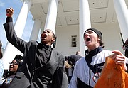 Corey Stuckey, left, an Armstrong High School freshman, and Sam Alburger, a junior at  Hermitage High School, join in a chant with the crowd of thousands at the state Capitol who turned out in Richmond last Saturday for the March for Our Lives. Corey was one of the student speakers at the rally.

