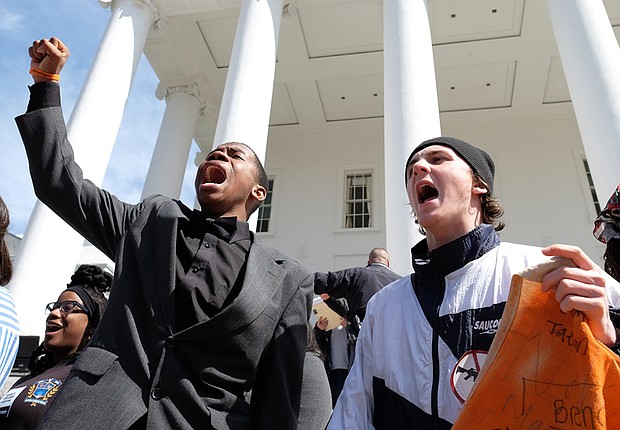 Corey Stuckey, left, an Armstrong High School freshman, and Sam Alburger, a junior at  Hermitage High School, join in a chant with the crowd of thousands at the state Capitol who turned out in Richmond last Saturday for the March for Our Lives. Corey was one of the student speakers at the rally.
