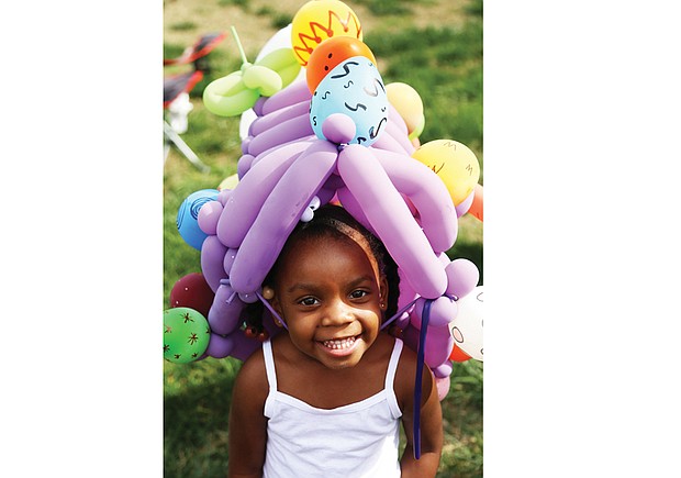 Laniyah Massenburg, 3, wears an ornate Easter bonnet made from balloons at the 2017 Easter on Parade celebration along Monument Avenue. Balloon art and bonnet making are among the activities featured in this year’s event Sunday, April 1.