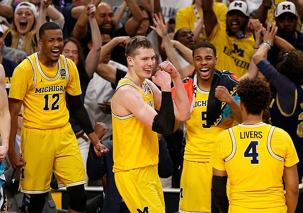 No. 3 Michigan has advanced to the national championship game with a 69-57 win over the 11th-seeded Ramblers, ending their magical run at the NCAA men's Final Four in San Antonio on Saturday./ Brynn Anderson/AP