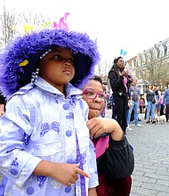 Audrey Ross, 4, pauses with her mother, Tarah Westont, to watch one of the performances at Easter on Parade.
