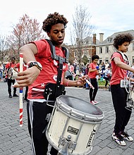 The Ephesus Pathfinder Drumline, above, strikes up a beat that gets spectators grooving as the group parades and plays down the avenue.
