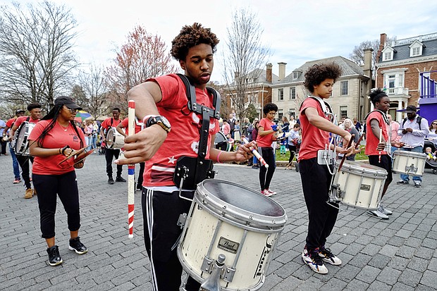 The Ephesus Pathfinder Drumline, above, strikes up a beat that gets spectators grooving as the group parades and plays down the avenue.
