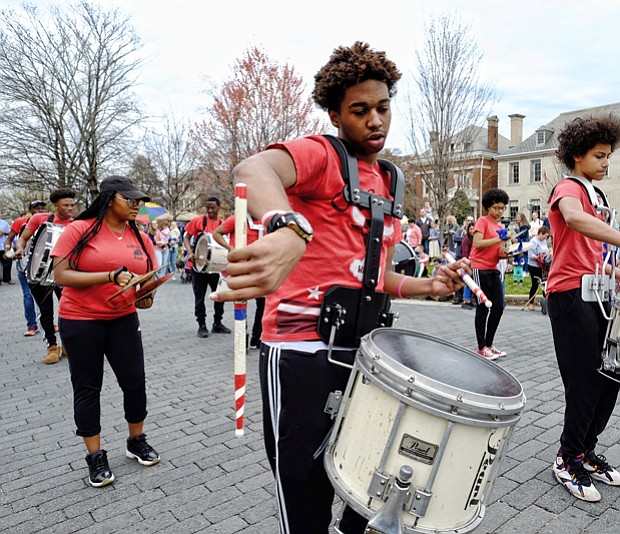 The Ephesus Pathfinder Drumline, above, strikes up a beat that gets spectators grooving as the group parades and plays down the avenue.
