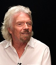 Richard Branson's spaceship fired up its rocket engine Thursday, marking the first powered test flight for the company since a fatal crash left it hamstrung in 2014.