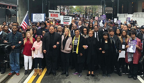 Relatives of Dr. Martin Luther King Jr. led more than 1,000 people on a march Monday in downtown Atlanta, where ...