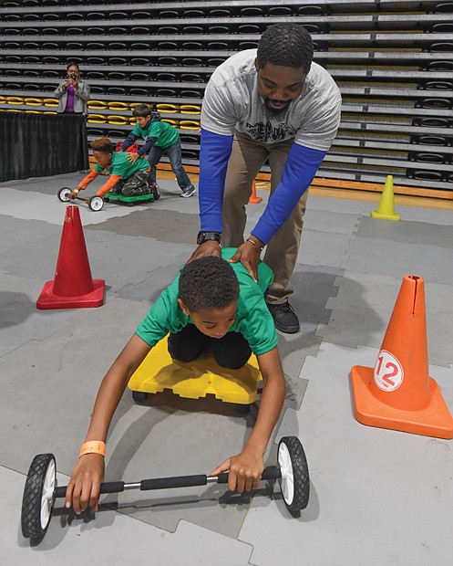 Sun Trust volunteer Jerry Ahiable directs Kingston Jackson, a fifth-grader at Chimborazo Elementary, through a mini-lesson. 