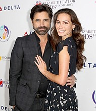 John Stamos and actress Caitlin McHugh welcomed a  newborn son.   CREDIT: Rachel Murray/Getty Images for mothers2mothers and The Elizabeth Taylor AIDS Foundation