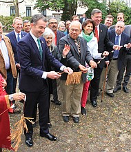 Gov. Ralph S. Northam cuts the ribbon dedicating “Mantle,” the new monument honoring Virginia’s Native American tribes, during a ceremony Tuesday. Among the dignitaries are, from Gov. Northam’s left, Frances Broaddus-Crutchfield of the Virginia Indian Commemorative Commission; Ken Adams, chief emeritus of the Upper Mattaponi tribe; former Virginia First Lady Susan Allen and her husband, former Gov. George Allen. Monument designer Alan Michelson also is in the crowd. Below, An infinity fountain with a black marble top inscribed with the names of Virginia’s Native American tribes is the centerpiece of the new monument in Capitol Square.