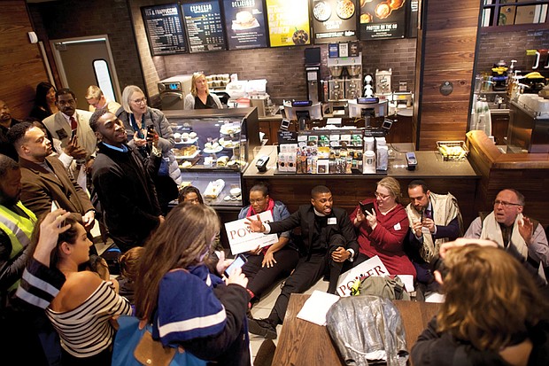 Ministers and rabbis stage a sit-in at the Center City Starbucks in Philadelphia to protest the arrest of two African-American men who were waiting at the coffee shop for a friend to arrive. The protest reflects the backlash against the company over the incident. The manager who called police to remove the alleged trespassers no longer works at the cafe.