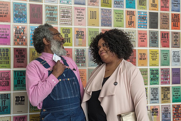 Artist Amos Paul Kennedy Jr. and Enjoli Moon, the ICA’s adjunct assistant curator of film, talk in front of Mr. Kennedy’s work in the opening exhibition.